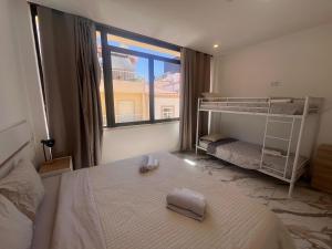 a bedroom with a bunk bed and a window at The Vault in Portimão +98 photos