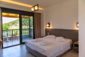 a hotel room with a bed and a balcony at Riviera Perdika Hotel in Perdika +132 photos