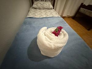 a bed with a white blanket on top of it at Apartamento 2 quarto e garagem G para 2 carro in Rio Verde
