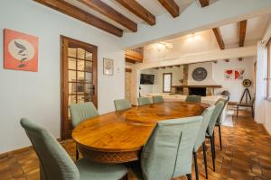 a dining room with a wooden table and chairs at Villa Paradis - Grande demeure familiale proche Puy-du-Foυ in Cholet +39 photos