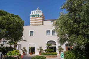 a hotel with a tower on top of it at Spazio Origine - Studio Hotel in Monopoli