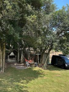 a group of people sitting at a table under some trees at Rancho Cantinella in Garibaldi