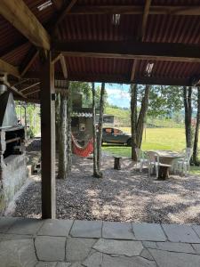 a patio with a table and chairs under a pavilion at Rancho Cantinella in Garibaldi