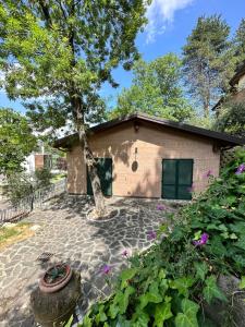 a brick building with a tree in front of it at B&B La Collina degli Ulivi in Zola Predosa