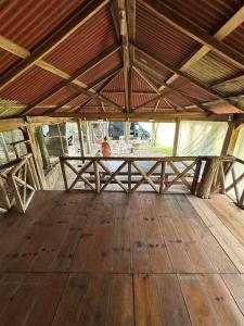 a large room with a wooden floor and a wooden table at Rancho Cantinella in Garibaldi +2 photos