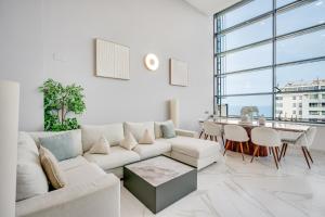 a living room with a white couch and a table at Penthouse Duplex with TOP Views! in Barcelona