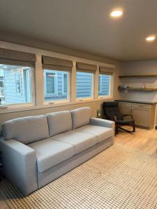 a living room with a couch and a desk at The Wave in Boston