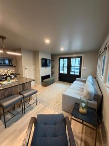 a living room with a couch and a kitchen at The Wave in Boston