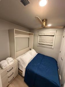 a small bedroom with a bed and a window at The Wave in Boston +11 photos