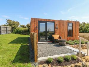 a tiny house with a sitting area in a yard at Alken The Stag in Bushmills