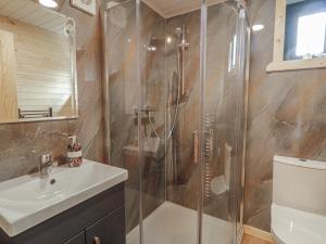 a bathroom with a shower and a sink at Alken The Stag in Bushmills +8 photos