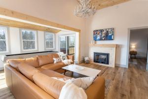 a living room with a couch and a fireplace at A Red Chalet in Newland