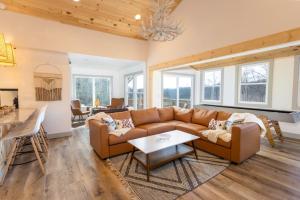a living room with a couch and a table at A Red Chalet in Newland