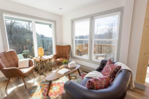 a living room with two chairs and a couch at A Red Chalet in Newland +29 photos