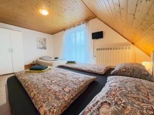 a bedroom with two beds and a television in it at Apartments Rupnik in Bovec