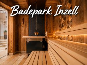 a barbershop with a bench in a room with wooden walls at Hardi's Hotel in Inzell +95 photos