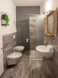 a bathroom with a toilet and a sink and a shower at Domus Rubra in Castelsardo +48 photos