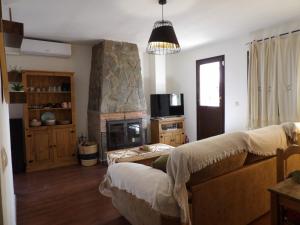 a living room with a couch and a fireplace at La Castaña y la Uva in Ohanes +26 photos