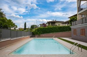 a swimming pool in front of a building at Myama Lake in Desenzano del Garda