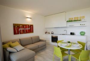 a living room with a couch and a table at Myama Lake in Desenzano del Garda