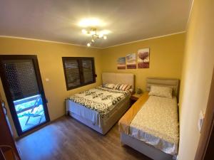 a bedroom with two beds and a window at City Centre in Žabljak