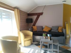 a living room with a couch and chairs at Hédoniste 1 in Herpy-lʼArlésienne