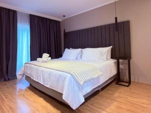 a bedroom with a large bed with a phone on it at HYN Hotel Boutique in General Belgrano +51 photos