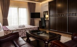 a living room with a couch and a table at Hotel Begolli in Prishtinë