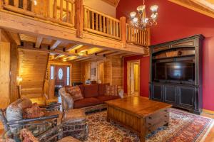 a living room with a couch and a tv at The Feisty Fox in Sugar Mountain