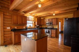 a kitchen with wooden cabinets and a counter top at The Feisty Fox in Sugar Mountain