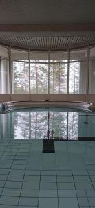 a large swimming pool in a room with windows at Tiera Resort in Taivalkoski