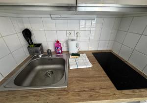 a kitchen counter with a sink in a kitchen at Studio Horizon Amiens in Amiens +1 photo