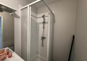 a shower stall in a bathroom with a sink at Studio Horizon Amiens in Amiens
