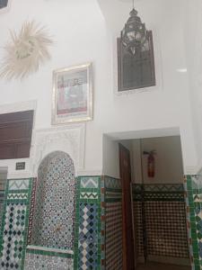 a room with a staircase with colorful tiles on the wall at Riad la Fíbula de Nora in Fez +69 photos