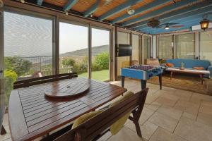 a screened in porch with a table and a chessboard at Villa Netofa (Kosher) in Mitspe Netofa