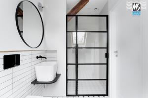 a bathroom with a sink and a mirror at Top Center VI in Gdynia