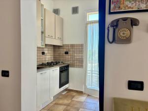 a kitchen with a stove and a clock on the wall at Casetta Rocca in Rocca San Giovanni +26 photos