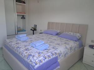 a bedroom with a bed with towels on it at Ulza Lake Escape in Ulëz +8 photos