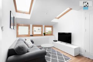 a living room with a couch and a tv at Top Center VI in Gdynia