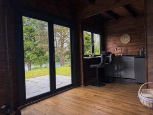 a kitchen with a large sliding glass door at Black Cat House Radailiai in Radailiai +5 photos
