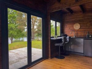 an open kitchen with a large sliding glass door at Black Cat House Radailiai in Radailiai