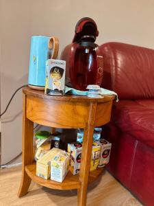 a coffee table with a tea kettle on top of it at Bastide en Margeride in Châteauneuf-de-Randon