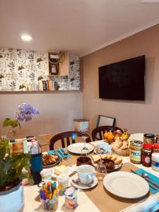 a dining room table with plates of food on it at Bastide en Margeride in Châteauneuf-de-Randon