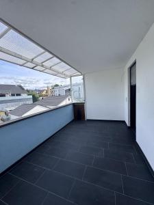 an empty balcony with a view of a building at Bayman Apartments in Ellhofen