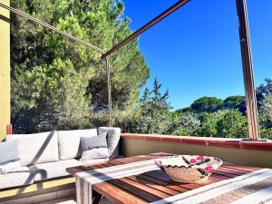 a patio with a couch and a table on a porch at Grace House in Marina di Sorso