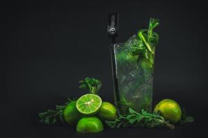 a drink with limes and a glass of liquid with lime at Xperience Hotel in Baños