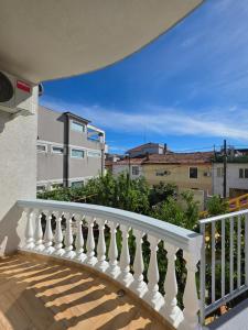 a balcony with white railings and a view of buildings at Eagle’s Nest in Shkodër