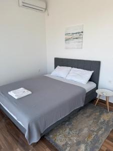 a bed with two pillows at Panorama View Holiday Home in Šušanj +16 photos