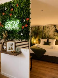 a bedroom with a bed with a flower wall at Spa et sauna - Loft Cataleya in Belfort