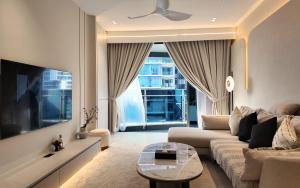 a living room with a couch and a table at IKON SUITE's E A T O N KLCC in Kuala Lumpur